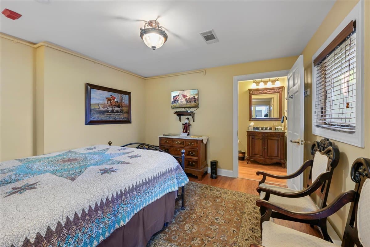 The Longstreet Chamber features a queen size bed, 2 chairs, dresser and TV.