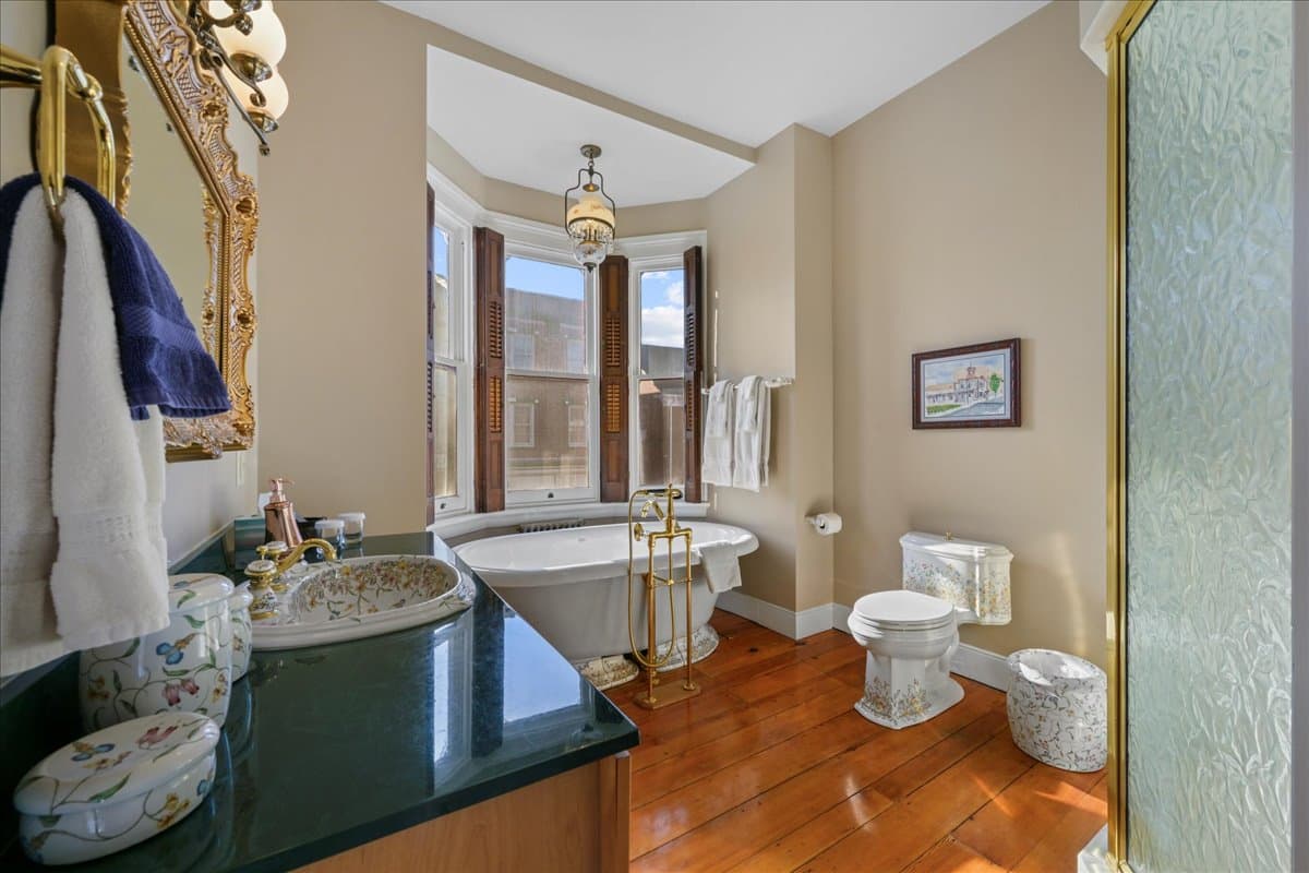 The Gettysburg Suite bathroom featuring an ornate Italian tub, toilet, and sink.