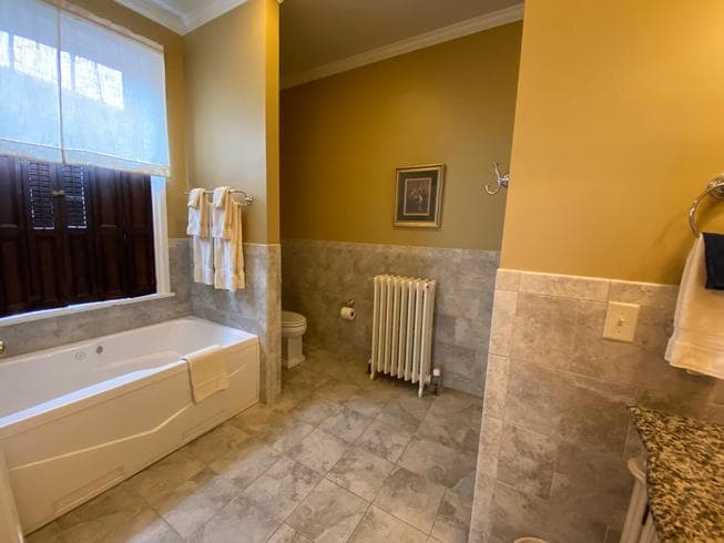 The Miss Dorothy Suite Bathroom includes a jetted tub for 2 and toilet.