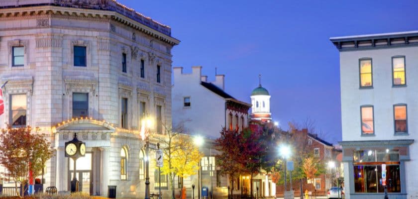 A tranquil evening view of a charming historic downtown area featuring elegant architecture and colorful autumn foliage.