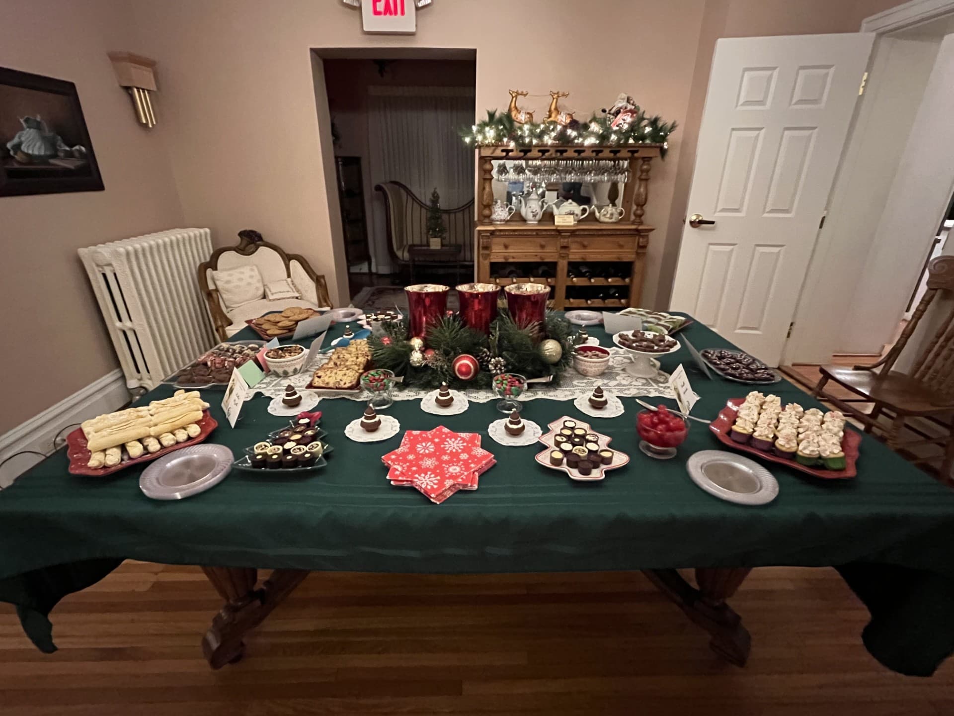 A festive table laden with an assortment of holiday desserts.