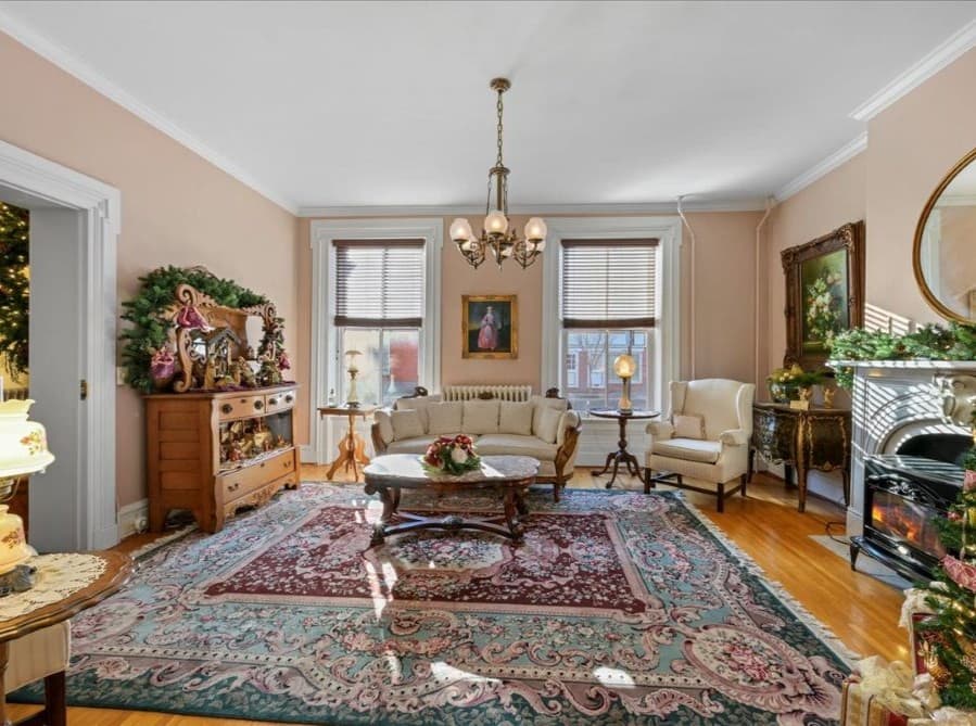 Pink parlor decorated for Christmas with gorgeous fireplace