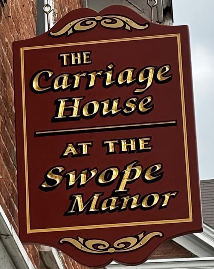 A sign for "The Carriage House at the Swope Manor."
