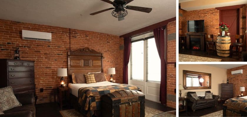 Carriage House Suite with exposed brick, fireplace, and queen bed at The Swope Manor.